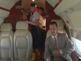 Lustful stewardesses suck their clients hard pecker on the plane